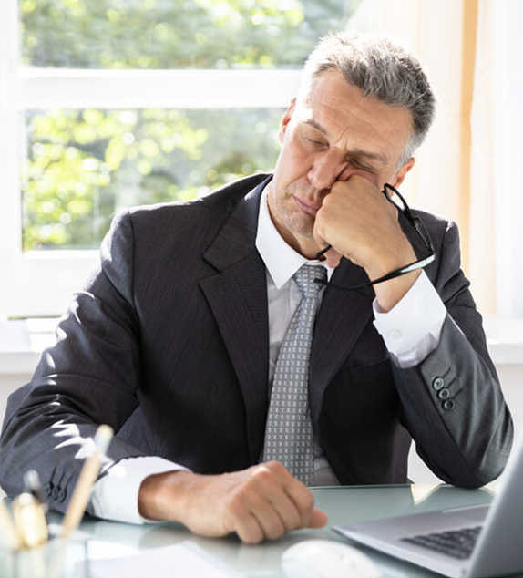 Businessman looking tired as a symptom of declining mental capacity.