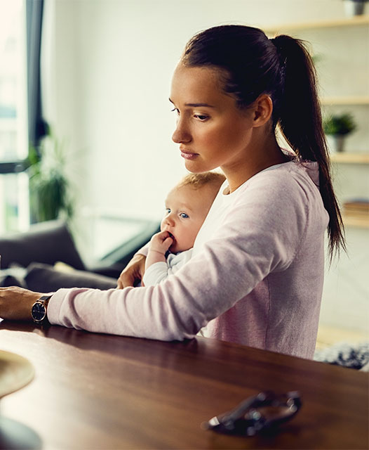 woman with postpartum depression holding baby